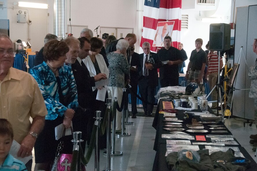 Members of the Siouxland community look at memorabilia from Col. George “Bud” Day at the community memorial service hosted by the 185th Air Refueling Wing in Sioux City, IA on August 3, 2013. (U.S. Air National Guard photo by Tech. Sgt. Oscar Sanchez/Released)   