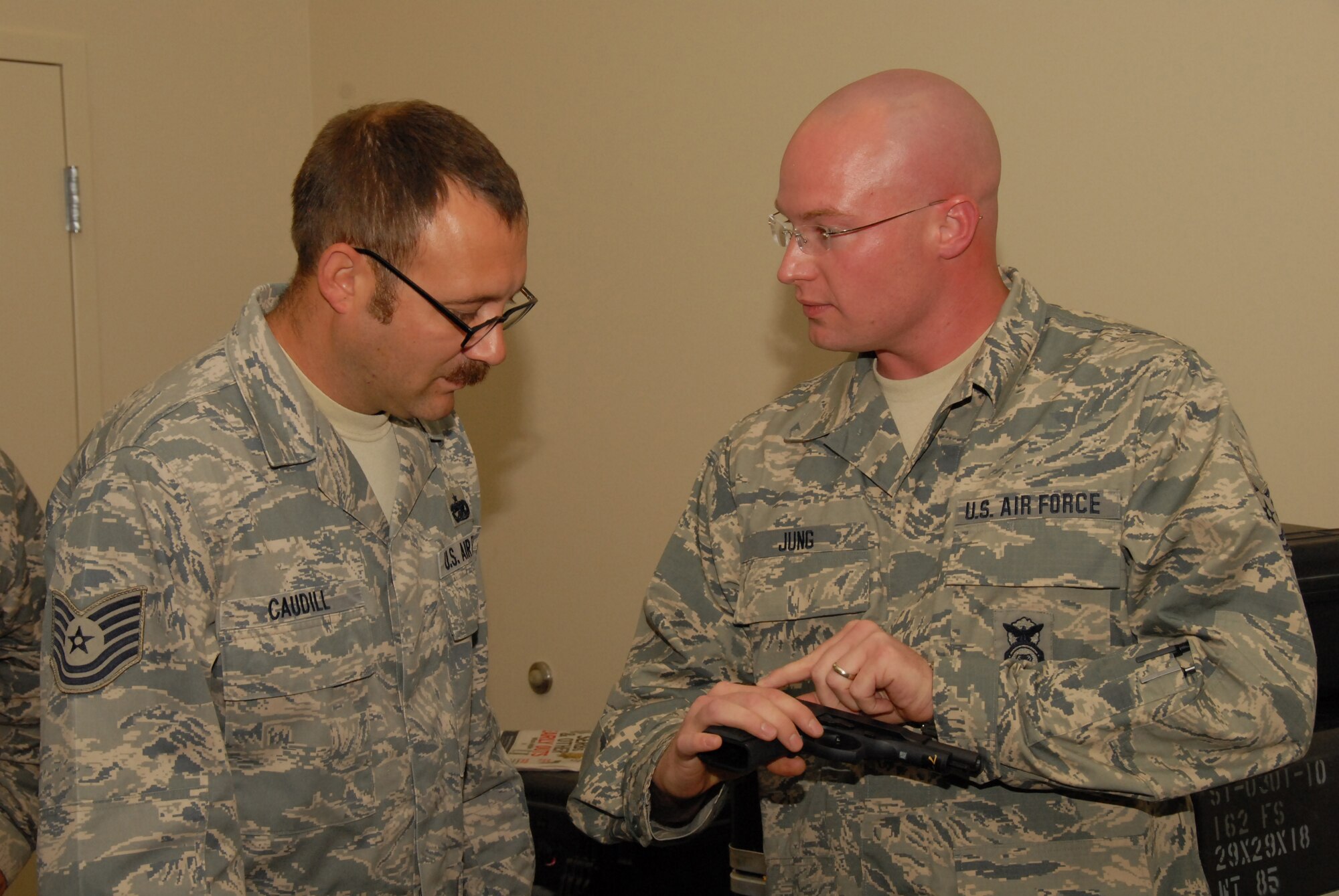 Tech. Sgt. Daniel Jung, 178th Security Forces, Ohio Air National Guard explains the concept of safe and clear to Tech. Sgt. Jonathon Caudill, 178th Logistics Readiness Squadron, Ohio Air National Guard during weapons training July 30, 2013 at Combat Readiness Training Center Alpena, Mich.  Jung and Caudill participated in the weapons training during the annual Alpena Michigan training exercise. (U.S. Air National Guard photo by Master Sergeant Seth Skidmore/Released)
