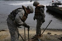 Soldiers with 502nd Multi Role Bridge Company, based at Fort Knox, Ky., place steel rods to secure the Improvised Ribbon Bridges during a training exercise at Engineer Point aboard Camp Lejeune, N.C., July 30, 2013. Marines with Bridge Company, 8th Engineer Support Battalion, 2nd Marine Logistics Group worked with soldiers to show them how to utilize the MK III Bridge Erection Boats instead of the MK II BEBs, and built together a continuous span across the water reaching more than 1,000 feet. 