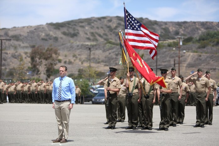 Sergeant Matthew T. Woodall, former squad leader, Bravo Company, 1st Battalion, 5th Marine Regiment, stands at attention as the national anthem is played during an award ceremony at the Camp San Mateo parade deck here, Aug. 2, 2013. Woodall, a native of Paducah, Ky., earned the Silver Star Medal, the nation's third highest military award for valor for his actions in Helmand province, Afghanistan, in support of Operation Enduring Freedom. A platoon-sized enemy force attacked Woodall and his Marines from several fortified positions during a security patrol mission in the Sangin district of Helmand, July 10 through 11, 2011. His daring actions ultimately defeated the enemy attack, killing four insurgents and wounding many others.