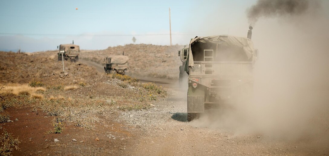 Marines with Transportation Service Company, Combat Logistics Battalion 3, drive 7-ton vehicles across the barren, volcanic terrain of Pohakuloa Training Area, Hawaii, July 23, 2013. The unit supported 2nd Battalion, 3rd Marine Regiment during Exercise Lava Viper. (U.S. Marine Corps photo by Cpl. Matthew Callahan)