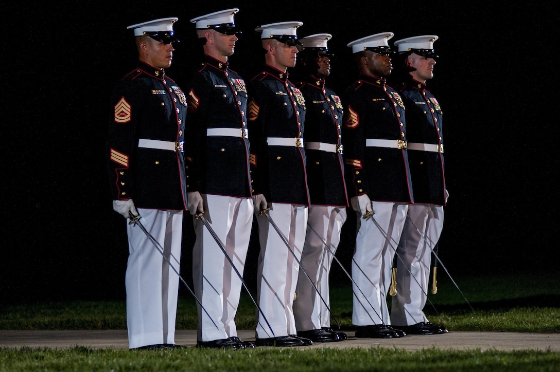 Platoon commanders report to the parade commander during a Friday Evening Parade at Marine Barracks Washington, D.C., Aug. 2. Staff noncommissioned officers held positions traditionally held by officers during this parade.