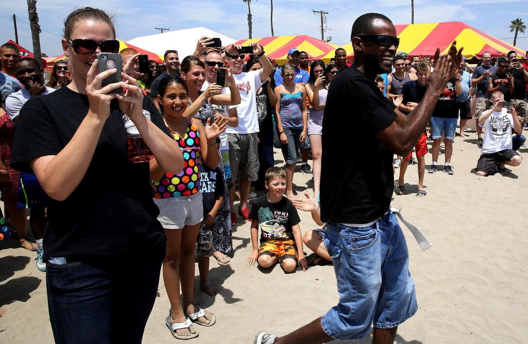 Marines and their families react to Col. Michael E. Cordero being dropped into the dunk tank during the first raffle at the battalion Family Day held at Del Mar Beach Resort here August 2. The battalion Family Day is an event to promote camaraderie and bonding for the service members and their families. 