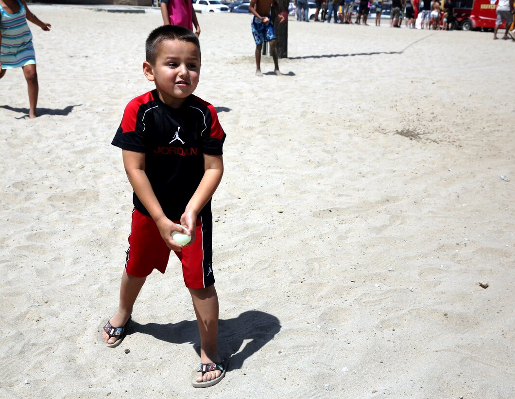Jayden, a 4-year-old, prepared to compete in a water balloon-throwing contest during the Headquarters and Support Battalion Family Day on Del Mar Beach Resort here August 2. Battalion Family Day is an event to promote camaraderie and bonding for the service members and their families. Peet is the son of Staff Sgt. Natalie Peet.