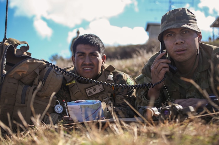 Sergeant Luis E. Herrera (left), a forward observer for Company G., Battalion Landing Team 2nd Battalion, 4th Marines, 31st Marine Expeditionary Unit, and a native of Chino Hills, Calif., works alongside Lance Bombardier Lolo Tuungafasi, a forward observer for 107 Battery, 4th Regiment, Royal Australian Artillery, and a native of Marrickville, Australia, to call in mortar fire during a four-day, live-fire exercise following the conclusion of Talisman Saber 13 here, July 31. The live-fire exercise included the coordination of fire-support assets from the 31st MEU; the USS Chung-Hoon, an Arleigh Burke-class AEGIS destroyer; the HMAS Perth III, an ANZAC Class frigate; and the Australian Army. The exercise provided effective and intense training to ensure U.S. and Australian forces are capable, interoperable, deployable on short notice and combat ready. The 31st MEU is the Marine Corps' force in readiness for the Asia Pacific region and the only continuously forward-deployed MEU. 