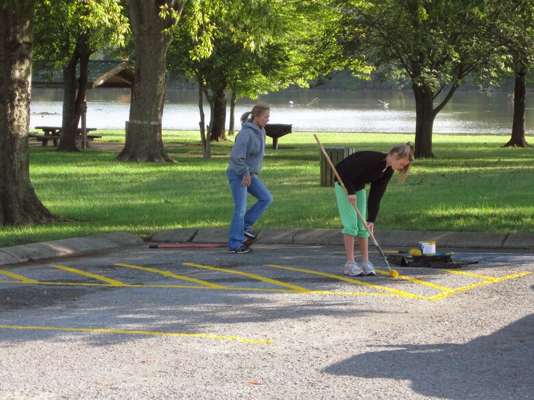 Volunteers paint lines at an Old Hickory Lake cleanup project.  Volunteers play an important role in cleanups at many U.S. Army Corps of Engineer parks and recreation areas.  Volunteers are needed for an upcoming cleanup at the Old Hickory Lake that include restriping Rockland and Station Camp Recreation Area parking areas, restoring and maintaining the Rockland Nature Trail, and trail maintenance and clean up at Shutes Branch Mountain Bike Trail.  