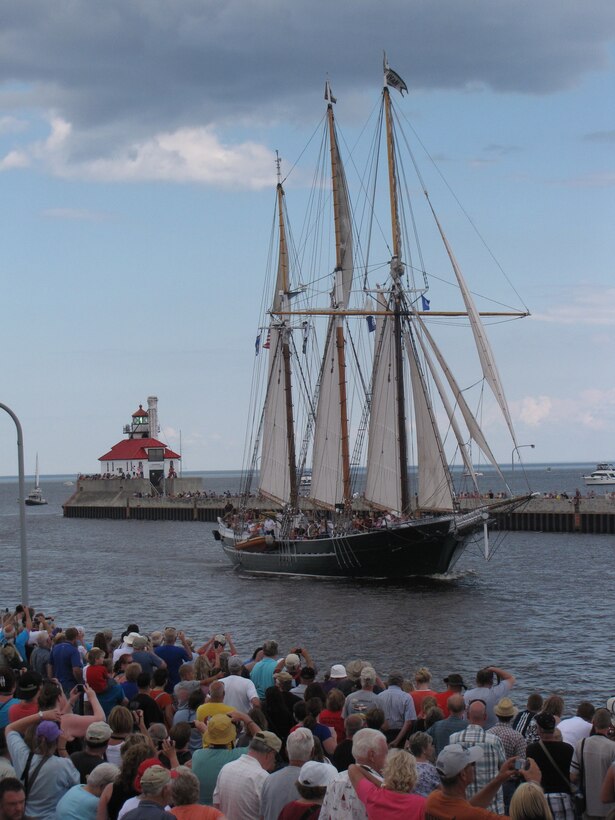 Visitors crowd along the Duluth Ship Canal to watch the S/V Dennis Sullivan, a replica of a Great Lakes schooner and flagship of Wisconsin, sail through for the Parade of Sails July 25, 2013. The ship operates as a floating classroom and goodwill ambassador for the state of Wisconsin and offers educational day sails and private charters from May through September.