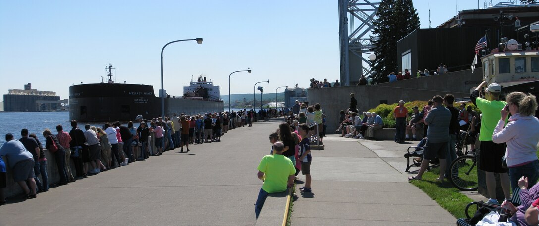 Crowds line up along Canal Park in Duluth, Minn. as the Mesabi Miner heads out of the shipping canal July 2, 2013.