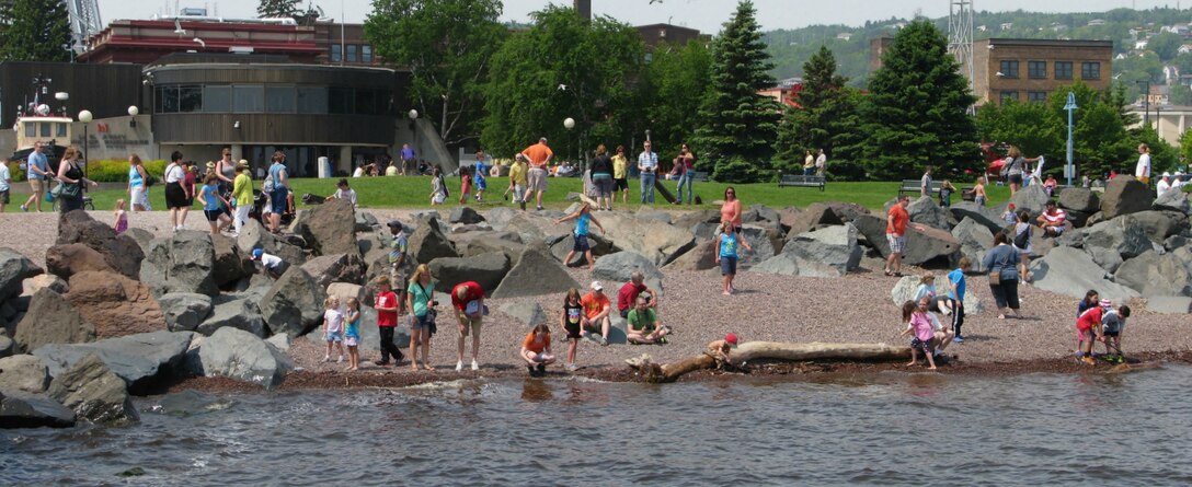 Children skip rocks at Canal Park in Duluth, Minn.
