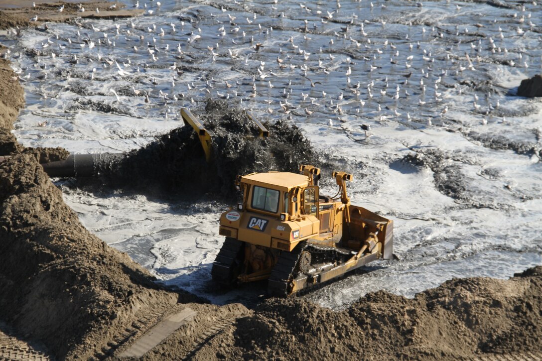 VIRGINIA BEACH, Va. – Contractors use bulldozers to spread sand at the Oceanfront’s 34th Street Jan. 10, 2013. The work was part of the Virginia Beach Hurricane Protection and Beach Renourishment Project, which added 1,440,250 cubic yards of dredged sand between 15th and 70th streets. Two hopper dredges, tasked by the Norfolk District, U.S. Army Corps of Engineers, cycled from navigational channels north of Cape Henry to pump-out landing stations where dredged material was piped onshore.