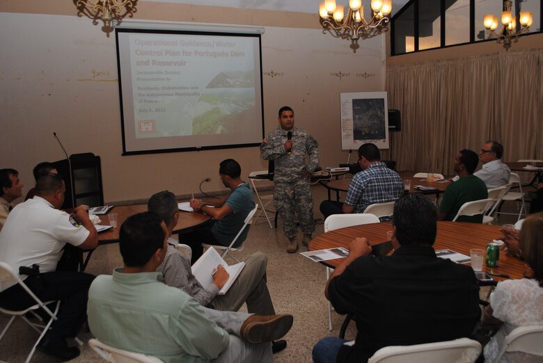 Capt. Juan Cordon, deputy commander for the Antilles,  welcomes the more than 30 residents from Ponce and nearby communities who attended a public meeting July 9 to learn more about construction progress and intended operations for the flood control structure. 