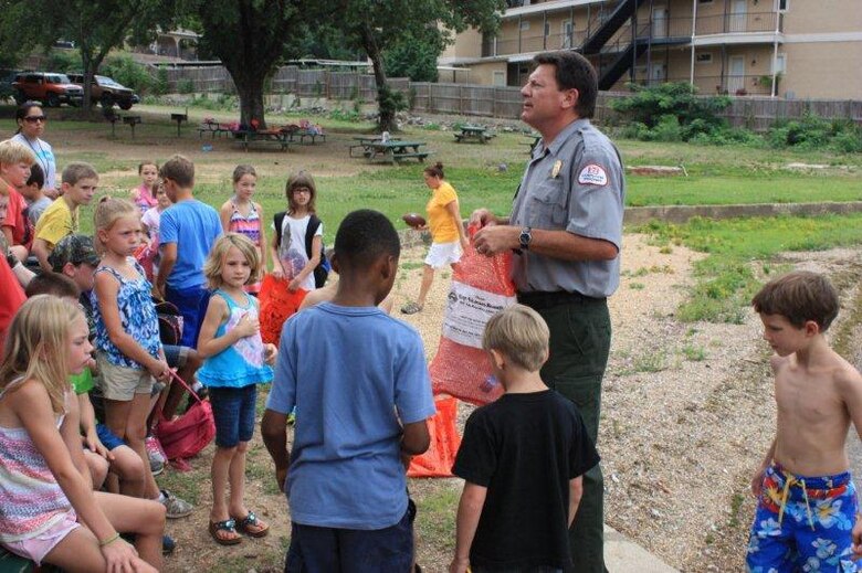 Swim Camp Photo - Brian Westfall, U.S. Army Corps of Engineers Natural Resource Specialist/ Ranger teaches youth about water safety.

The camp is geared towards youth aged 5-13 years, with approximately 100 youth having enrolled this year. Through this partnership, the educational camp includes a Fun Day at Arc Isle, a public park at Lake Hamilton. This Fun Day at Arc Isle is one of the educational field trips which gives the youth the opportunity to swim in Lake Hamilton.
