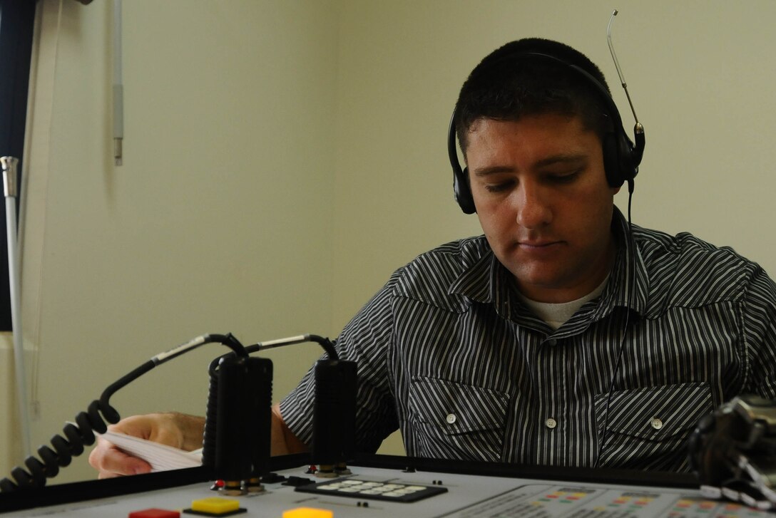 U.S. Army Special Agent Brandon Claridge, 102nd Military Police Criminal Investigation Command, reviews information before speaking with a role-playing hostage taker during a training scenario Aug. 1, 2013, on Andersen Air Force Base, Guam. Department of Defense and other U.S. government law enforcement agents took part in a two-week long hostage training class conducted by DoD contracted trainers. (U.S. Air Force photo by Airman 1st Class Emily Bradley/Released)