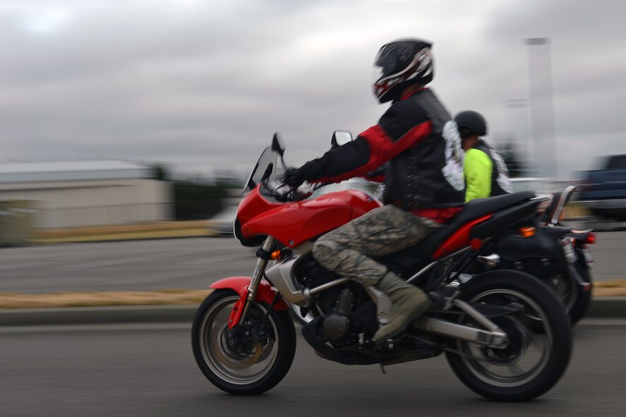 Airman 1st Class Orrin Fenwick (front), Green Knights Military Motorcycle Club Chapter 3 member, rides alongside, GKMMC member Staff Sgt. Adam Kies, Aug. 1, 2013 at Joint Base Lewis-McChord, Wash. The GKMMC Chapter 3 is a nonprofit organization that focuses on mentoring safe riders and volunteering in the local community. (U.S. Air Force photo/Airman 1st Class Jacob Jimenez)     
