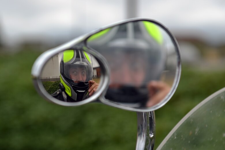 Staff Sgt. Joshua Borushko, 62nd Aircraft Maintenance Squadron motorcycle safety representative and Green Knights Military Motorcycle Club Chapter 3 president, lowers his visor prior to a ride Aug. 1, 2013 at Joint Base Lewis-McChord, Wash. The chapter is a non for profit organization composed of more than 25 members. (U.S. Air Force photo/Airman 1st Class Jacob Jimenez)