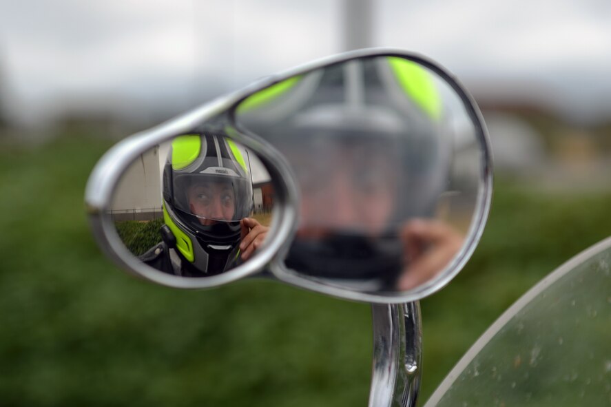 Staff Sgt. Joshua Borushko, 62nd Aircraft Maintenance Squadron motorcycle safety representative and Green Knights Military Motorcycle Club Chapter 3 president, lowers his visor prior to a ride Aug. 1, 2013 at Joint Base Lewis-McChord, Wash. The chapter is a non for profit organization composed of more than 25 members. (U.S. Air Force photo/Airman 1st Class Jacob Jimenez)