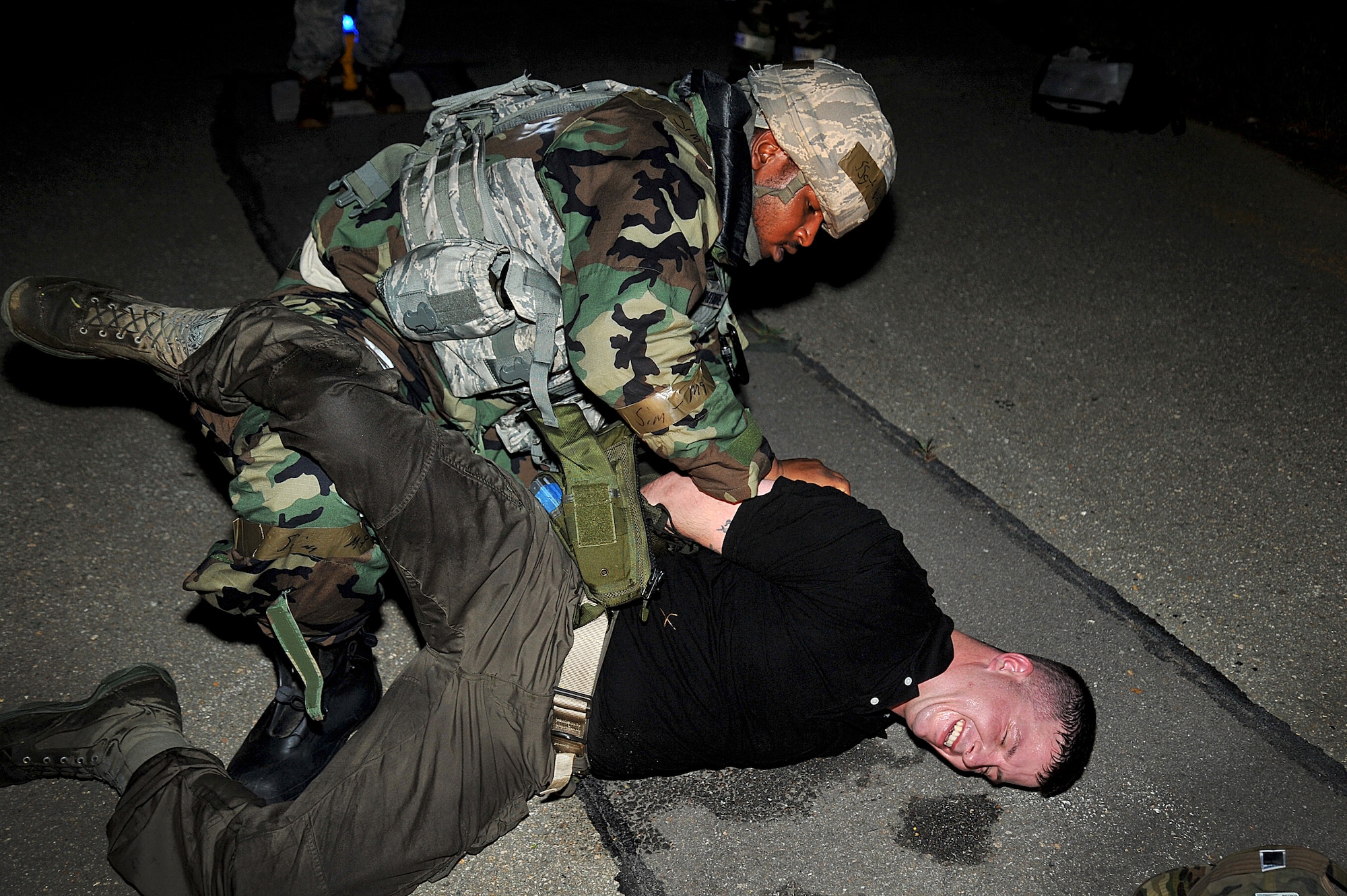 Staff Sgt. Bryce Whitmore, 51st Security Forces Squadron patrolman, checks over an opposing forces member for any weapons before he takes him in as a prisoner of war during Operational Readiness Exercise Beverly Midnight 13-03 at Osan Air Base, Republic of Korea, August 6, 2013. The exercise highlights Osan Airmen’s ability to position, employ and sustain forces, and showcase operational readiness. (U.S. Air Force photo/Staff Sgt. Emerson Nuñez)