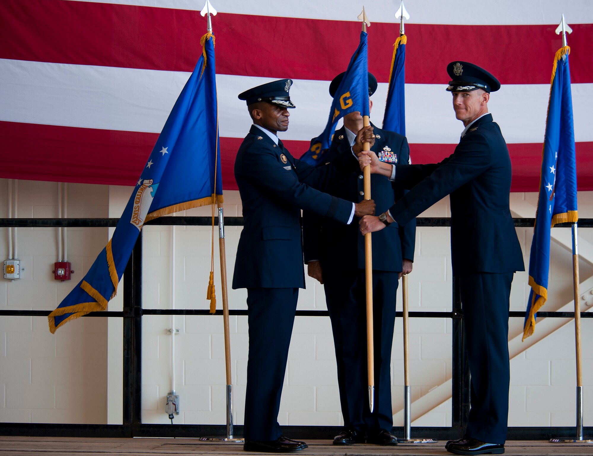 U.S. Air Force Lt. Gen. Darren McDew, 18th Air Force commander, presents Col. Jeffery S. Brown, 317th Airlift Group (AG) commander, with the group guideon Aug. 5, 2013, at Dyess Air Force Base, Texas. The passing of the guideon represents Brown’s acceptance of command over the 317th AG. (U.S. Air Force photo by Airman 1st Class Damon Kasberg/Released)
