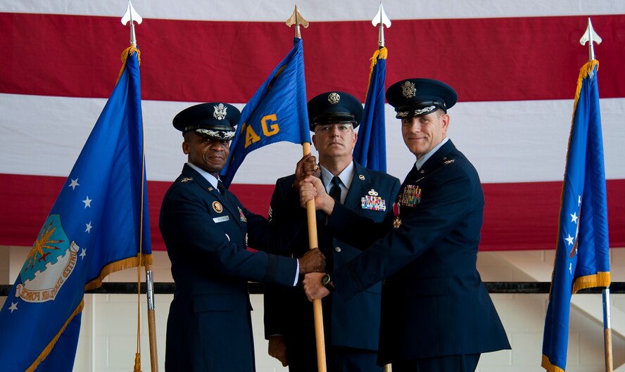 U.S. Air Force Lt. Gen. Darren McDew, 18th Air Force commander, relieves Col. Walter Ward, 317th Airlift Group (AG) commander, of command of the 317th AG during a change of command ceremony Aug. 5, 2013, at Dyess Air Force Base, Texas. (U.S. Air Force photo by Airman 1st Class Damon Kasberg/Released)