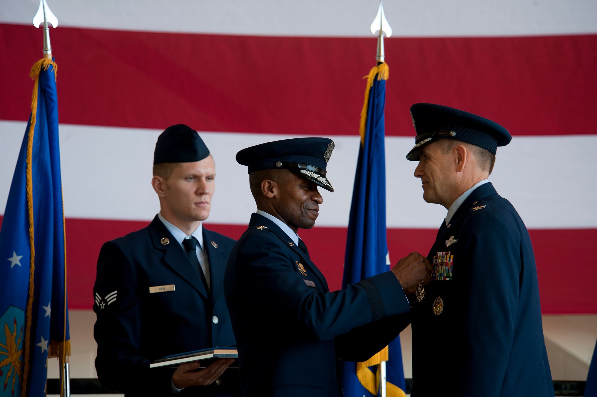 U.S. Air Force Lt. Gen. Darren McDew, 18th Air Force commander, presents Col. Walter Ward, 317th Airlift Group commander, with a Legion of Merit medal Aug. 5, 2013, during a change of command ceremony at Dyess Air Force Base, Texas. The Legion of Merit is a military award of the U.S. Armed Forces that is given for exceptionally meritorious conduct in the performance of outstanding services and achievements. The decoration is issued both to United States military personnel and to military and political figures of foreign governments. (U.S. Air Force photo by Airman 1st Class Damon Kasberg/Released)
