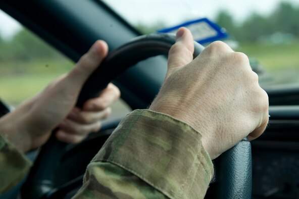 An Airman prepares to negotiate through a driving course as part of the Combat Aviation Advisor Military Qualification Skills Course at Eglin Range, Fla., June 18, 2013.  Airmen practiced shuffle-steering, a tactic where the drive shuffles the steering wheel, instead of the traditional hand-over-hand method, for better handling and to prevent injury to the arms in case the airbag deploys due to a collision.  (U.S. Air Force photo by Airman 1st Class Benjamin Kim)