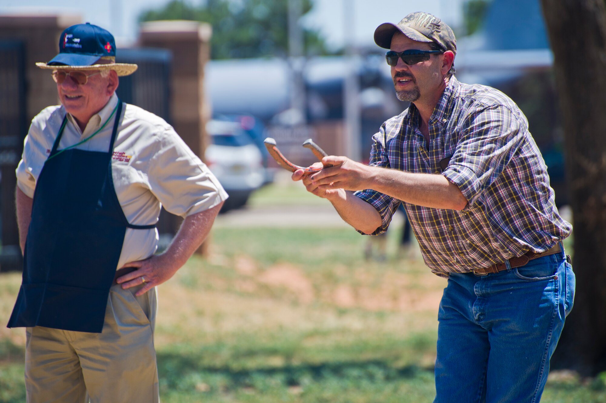 Attendees of Cannon Appreciation Day participate in a game of horseshoe at Cannon Air Force Base, N.M., Aug. 2, 2013. The Clovis/Curry County Chamber of Commerce, Committee of Fifty and the Clovis Industrial Development Corporation came together to sponsor the event for members of the Cannon community. (U.S. Air Force photo/by Airman 1st Class Xavier Lockley)