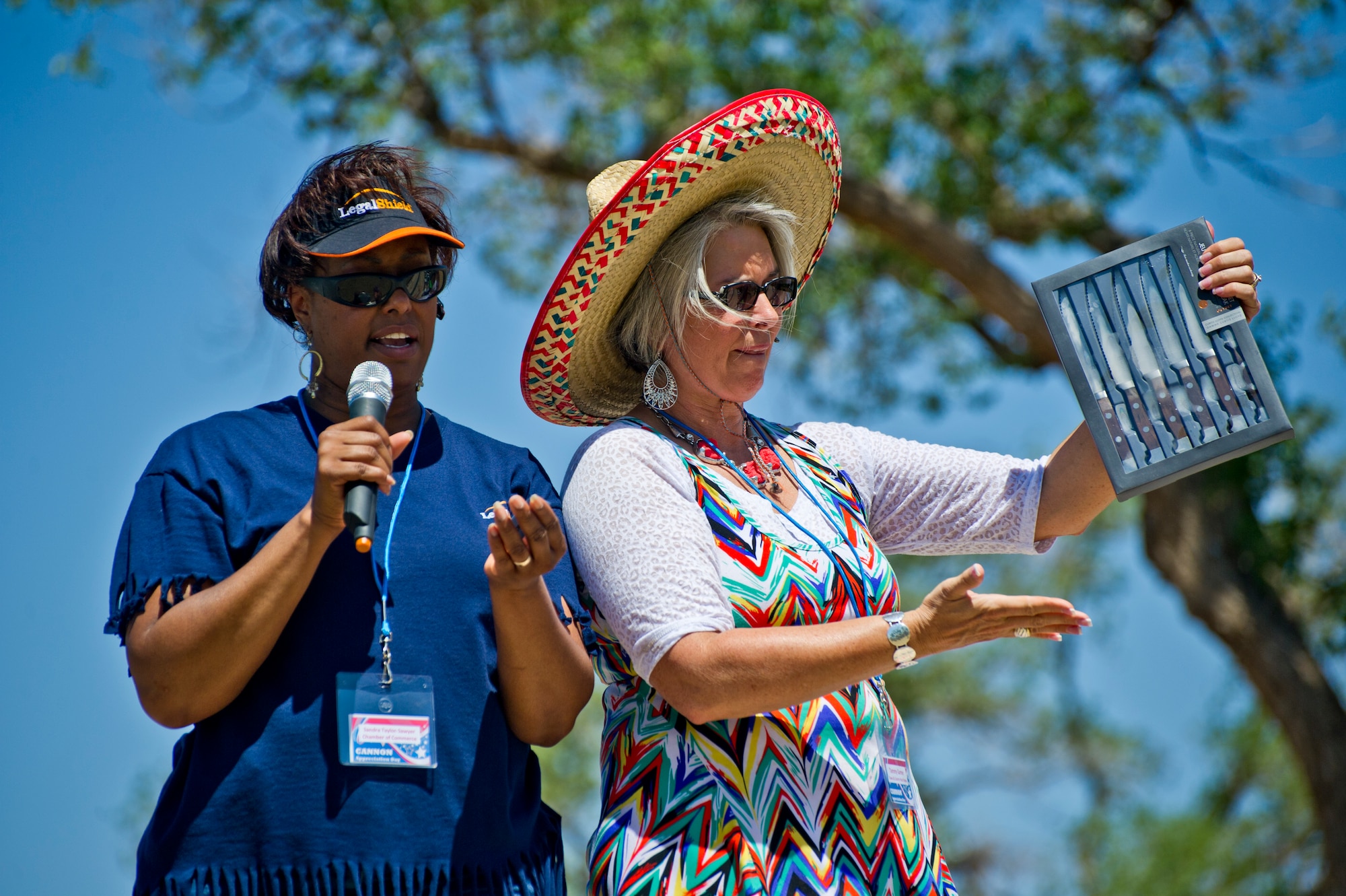 Sandra Taylor-Sawyer, Clovis/Curry County Chamber of Commerce, and Tammy Garner, Town and Country Real Estate, read off raffle ticket numbers during Cannon Appreciation Day at Cannon Air Force Base, N.M., Aug. 2, 2013. The Clovis/Curry County Chamber of Commerce, Committee of Fifty and the Clovis Industrial Development Corporation came together to sponsor the event for members of the Cannon community. (U.S. Air Force photo/by Airman 1st Class Xavier Lockley)
