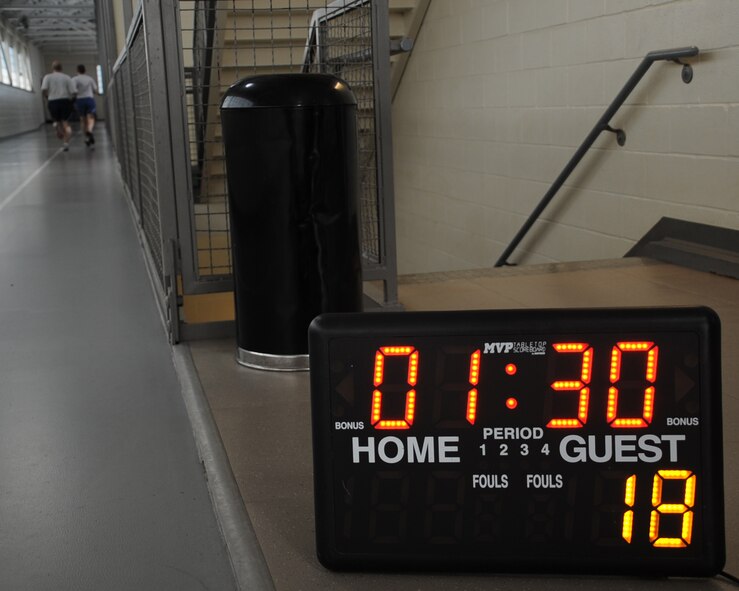 A clock is used to keep time during the 1.5 mile run portion of a physical fitness test on Barksdale Air Force Base, La., Aug. 5, 2013. Airmen must meet the minimum standard in each of the four sections in order to pass the test. (U.S. Air Force photo/Senior Airman Sean Martin)