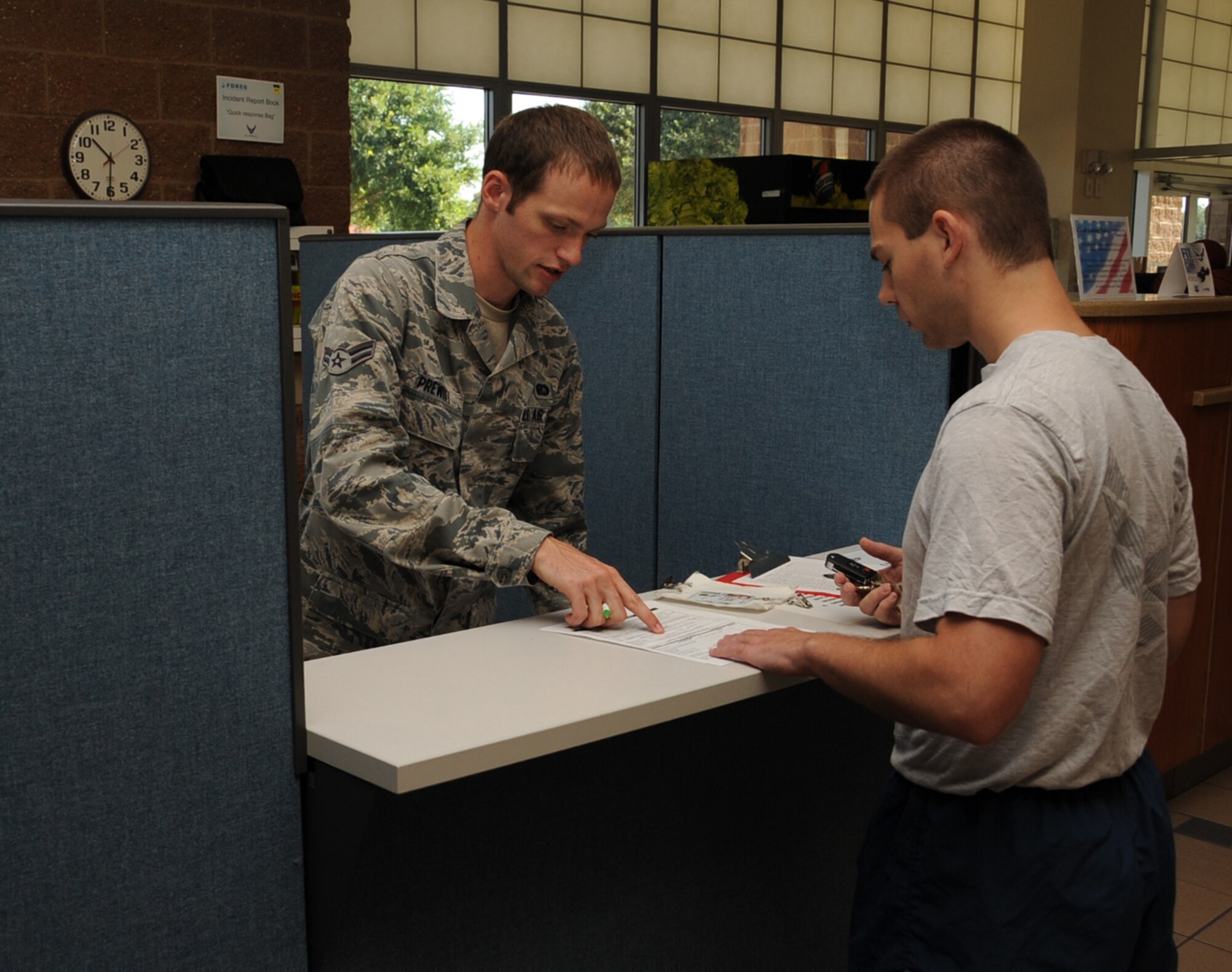 Airman 1st Class Ryan Prewitt, 2nd Force Support Squadron fitness specialist, signs in Senior Airman Joseph Trahan, 2nd Aircraft Maintenance Squadron crew chief, for his physical fitness test on Barksdale Air Force Base, La., Aug. 5, 2013. The Air Force physical fitness test is comprised of four components, an abdominal circumference, push-ups, sit-ups and a 1.5 mile run or 1 mile walk. (U.S. Air Force photo/Senior Airman Sean Martin)
