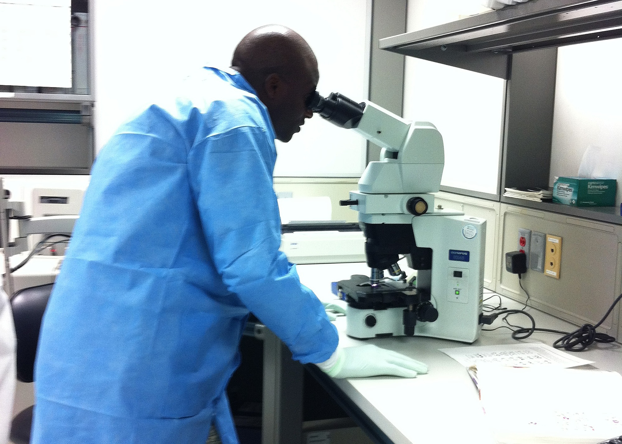 Col. Brian A. Hill, 92nd Air Refueling Wing vice commander, looks at a complete blood count manual differential through a hematology microscope at the 92nd Medical Group on July 26, 2013. Hill was doing this in part of his immersion into Team Fairchild's Mission. (Courtesy Photo)