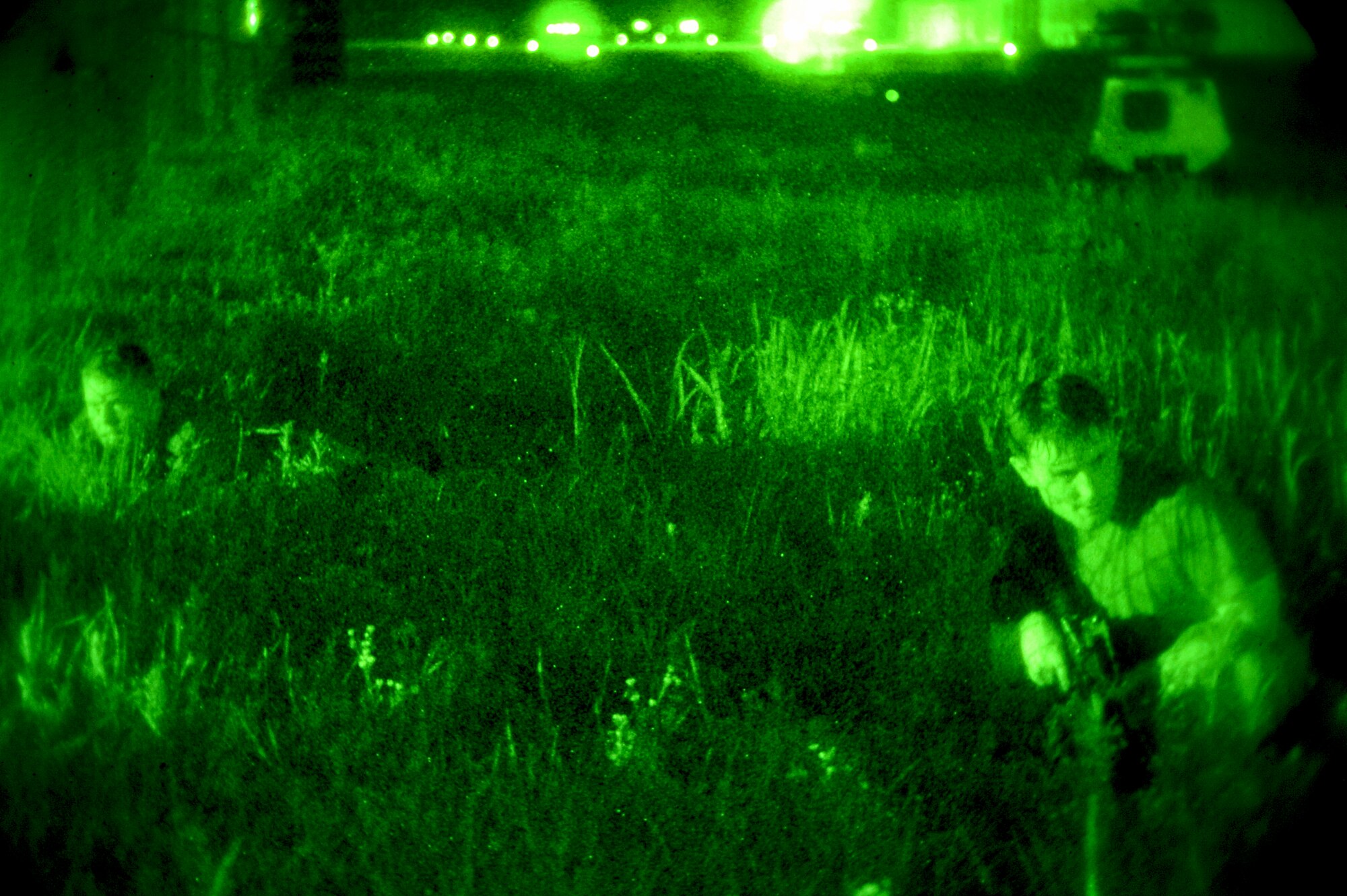 Opposing forces personnel take cover as they move in during a raid on the flight line during Operational Readiness Exercise Beverly Midnight 13-03 at Osan Air Base, Republic of Korea, August 6, 2013. The OPFOR personnel are comprised of Airmen assigned to Osan AB who volunteered to represent enemy personnel to assist with training purposes in different scenarios (U.S. Air Force photo/Staff Sgt. Emerson Nuñez)