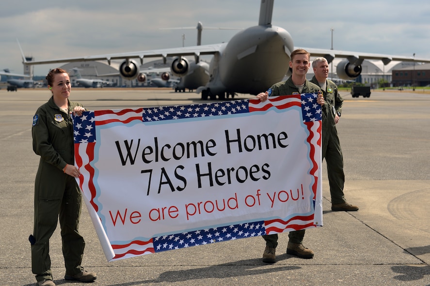 Airman 1st Class Christine Briggs and Jeramey Reamer, 7th Airlift Squadron loadmasters, wait at Joint Base Lewis-McChord, Wash., Aug. 3, 2013, for the arrival of members from their squadron returning from a 60-day deployment. The 62nd Airlift Wing's four active duty flying squadrons share responsibility for the deployed squadron and rotate operating the 817th Expeditionary Airlift Squadron continuously. (U.S. Air Force photo/Airman 1st Class Jacob Jimenez) 