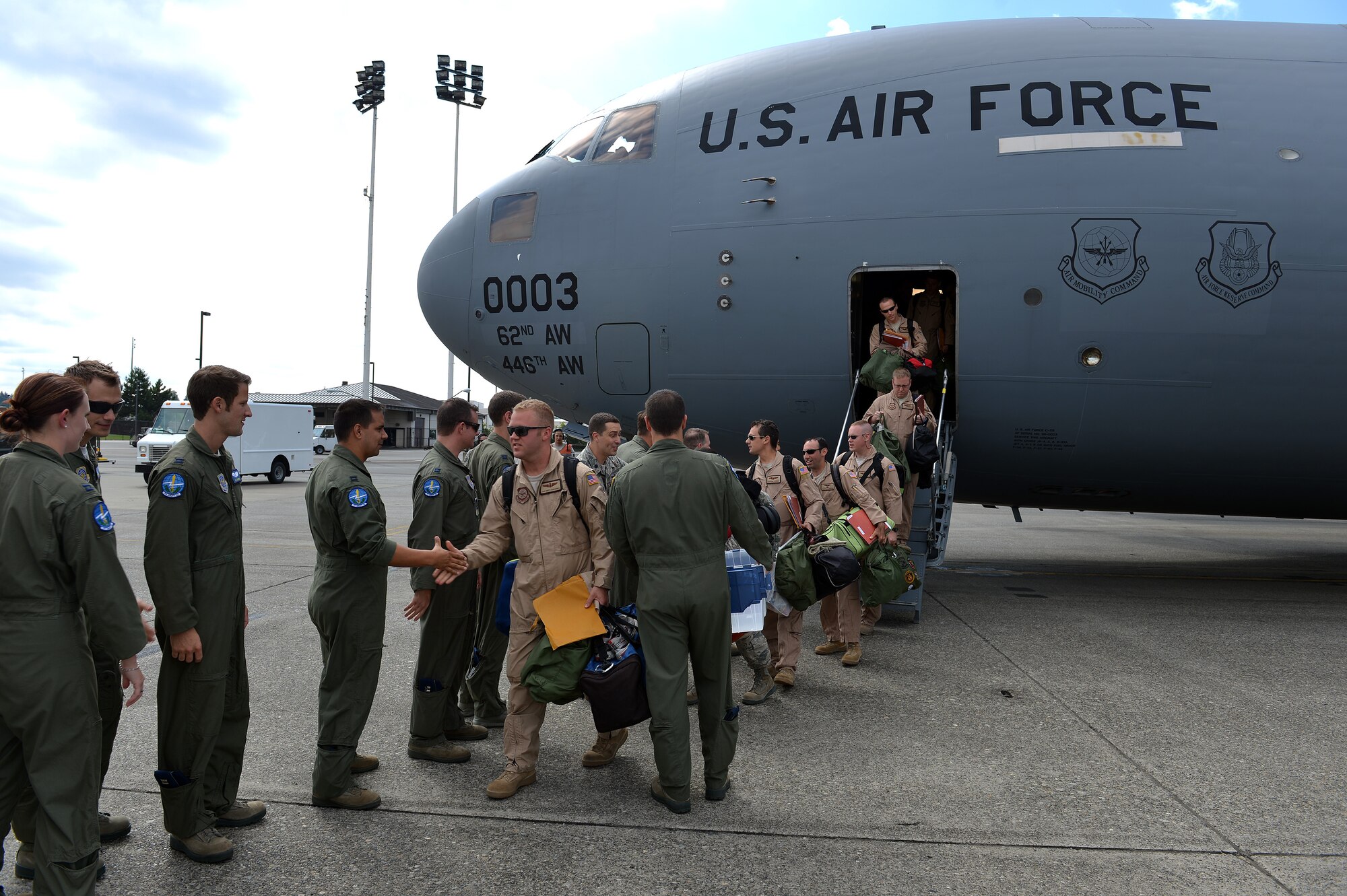 Airmen from the 7th Airlift Squadron are welcomed home at Joint Base Lewis-McChord, Wash., Aug. 3, 2013, after returning from a 60-day deployment. During their deployment, the 7th AS worked with Airmen from Elmendorf Air Force Base, Alaska and Joint Base Pearl Harbor-Hickam, Hawaii in support of Operation Enduring Freedom. (U.S. Air Force photo/Airman 1st Class Jacob Jimenez)