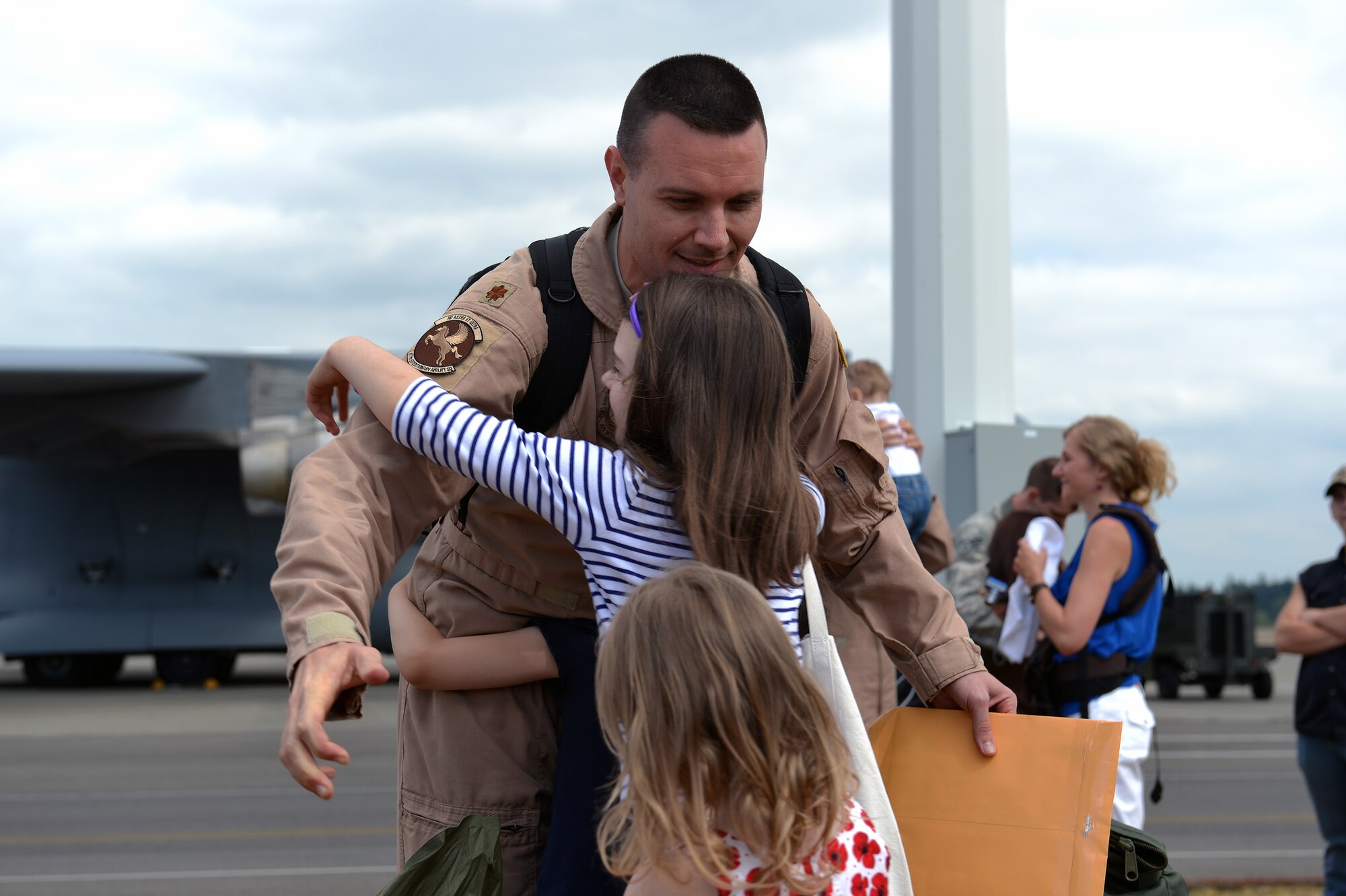 Maj. Myers Gray, 7th Airlift Squadron pilot, greets family members at Joint Base Lewis-McChord, Wash., after his return from a 60-day deployment, Aug. 3, 2013. The 7th AS was deployed as the 817th Expeditionary Airlift Squadron operating out of two bases, managing and flying missions in and around Southwest Asia. (U.S. Air Force photo/Airman 1st Class Jacob Jimenez)