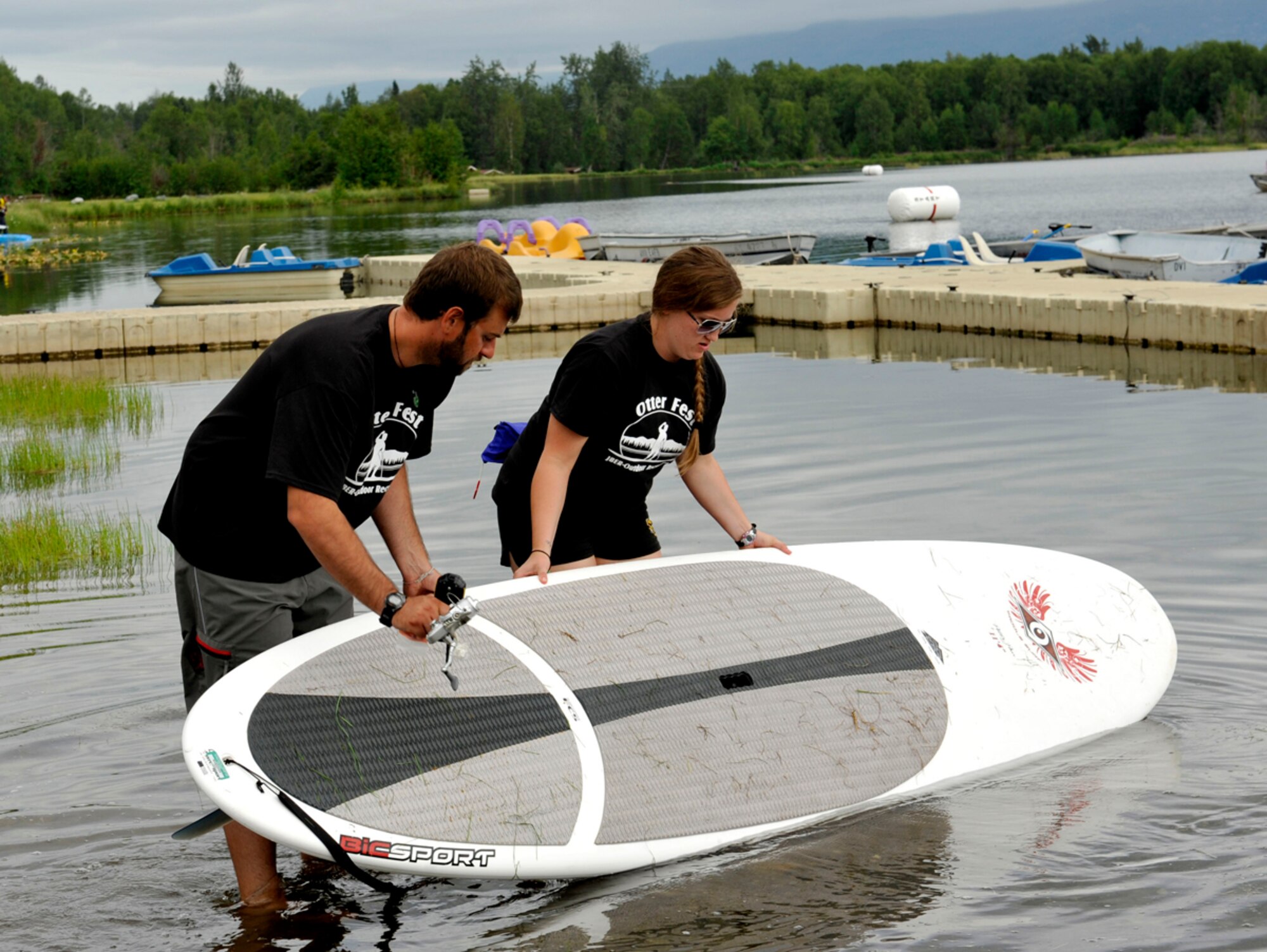 Trevor Bird, Outdoor Recreation Center supervisory recreation specialist (left), and Erica Stottard, Outdoor Recreation Center outdoor adventure programs student intern, prepare for the stand-up-board competition during Otter Fest on Joint Base Elmendorf-Richardson, Alaska, July 27. The stand-up-board races was the last race of the inaugural Otter Fest hosted by the Outdoor Recreation Center. (U.S. Air Force photo/Airman 1st Class Tammie Ramsouer)