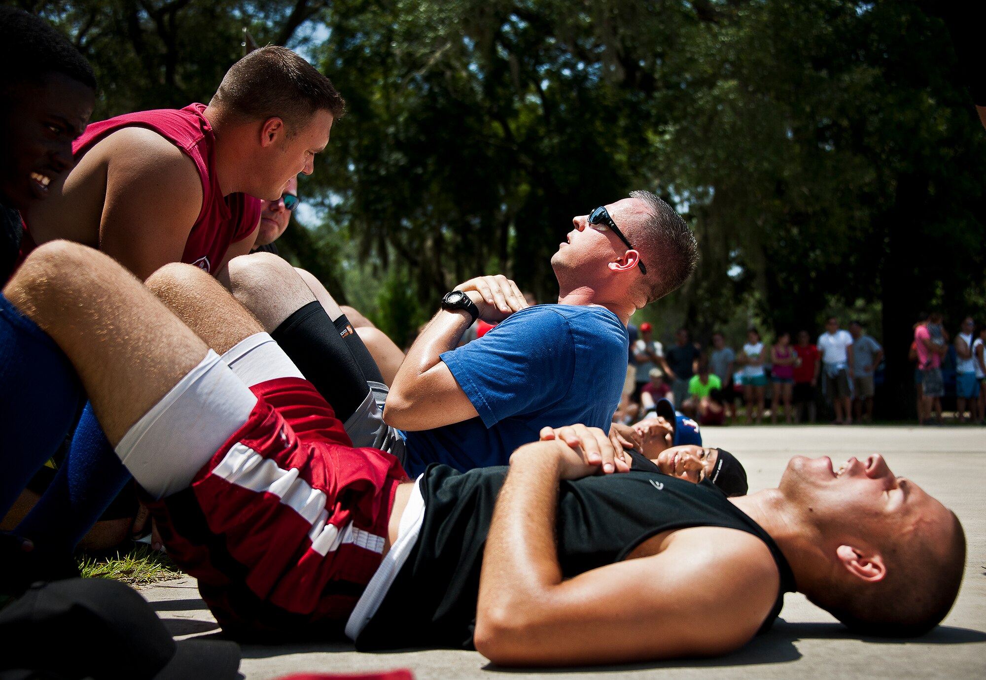 Staff Sgt. James Ellis, performs sit-ups for his 16th Electronic Warfare Squadron team during a push-up, sit-up competition at the 53rd Wing picnic Aug. 2.  The annual event includes physical fitness activities throughout the day along with a cook-out for lunch.  (U.S. Air Force photo/Samuel King Jr.)