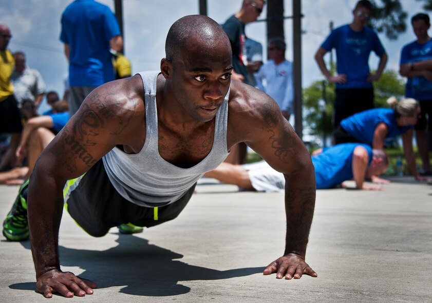 Senior Airman Ryan Thomas, of the 16th Electronic Warfare Squadron, performs push-ups for his 16th Electronic Warfare Squadron team during a push-up, sit-up competition at the 53rd Wing picnic Aug. 2.  The annual event includes physical fitness activities throughout the day along with a cook-out for lunch.  (U.S. Air Force photo/Samuel King Jr.)