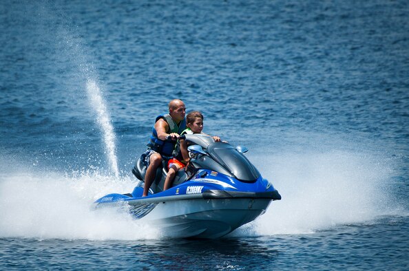 A father and son ride a jet ski along Boggy Bayou near Eglin Air Force Base, Fla., Aug. 2.  Eglin offers many outdoor recreation gear and activities to enjoy.  For more information, or to see what’s available go to www.eglinforcesupport.com. (U.S. Air Force photo/Samuel King Jr.)