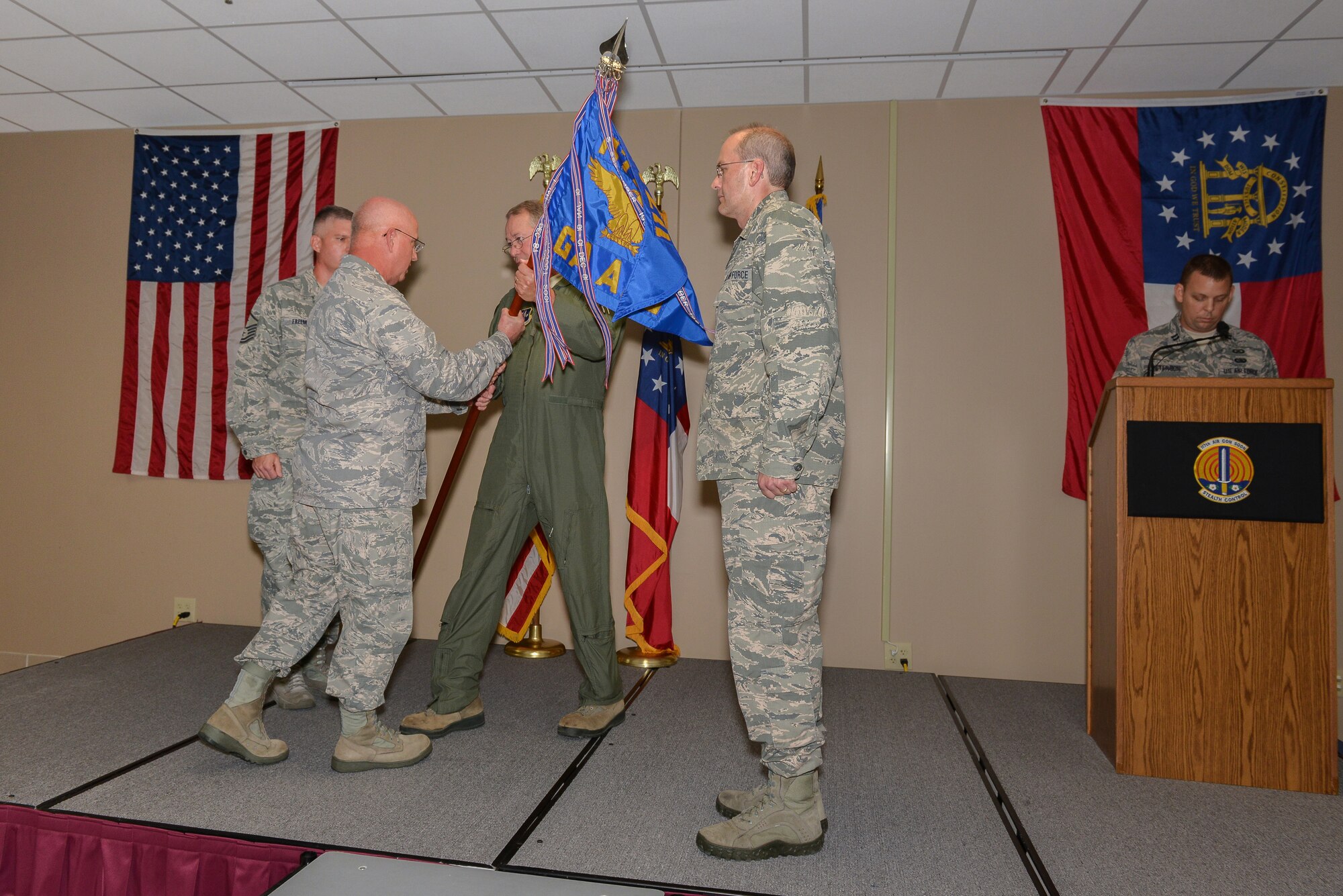 Maj. Gen. Thomas Moore, Georgia Air National Guard Commander, receives the 117ACS Guidon from Lt. Col. Victor Long during a Change of Command ceremony Aug. 3, 2013 at Hunter Army Airfield in Savannah. Ga. Long relinquished command of the 117ACS to Lt. Col. Ronald N. Speir, Jr. (U.S. Air National Guard photo by Tech. Sgt. Charles Delano/released)