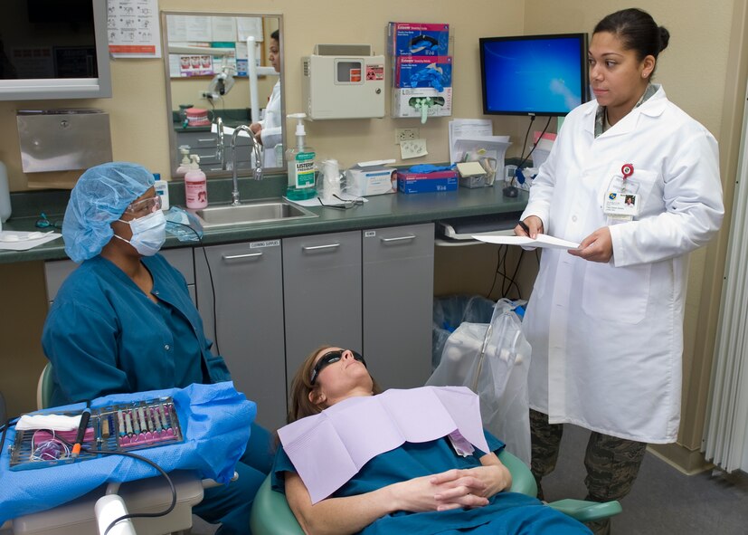 U.S. Air Force Tech. Sgt. Celeste Okokon, 7th Aerospace Medicine Squadron flight chief, verifies that a civilian dental hygienist is taking proper precautions to prevent the spread of germs and viruses March 7, 2013, at Dyess Air Force Base, Texas. During 2012, Okokon’s precision and attention to detail, aided in improving her units production by 30 percent and reducing the base population’s dental disease by 50 percent. (U.S. Air Force photo by Airman 1st Class Peter Thompson/Released)