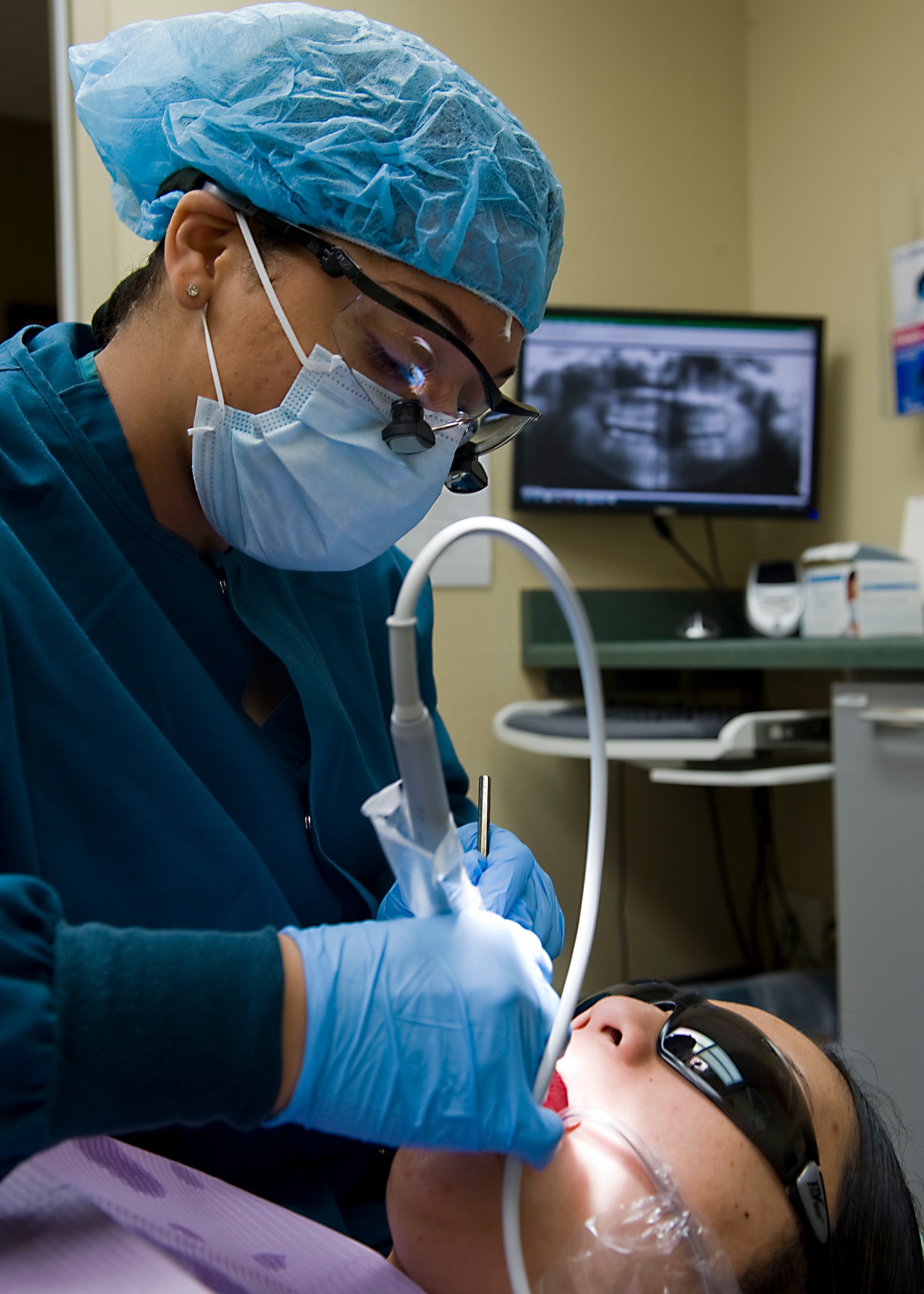 U.S. Air Force Tech. Sgt. Celeste Okokon, 7th Aerospace Medicine Squadron flight chief, cleans an Airman’s teeth March 7, 2013, at Dyess Air Force Base, Texas. Okokon, now a master sergeant, has been selected as one of the Air Force’s 12 Outstanding Airmen of the Year for 2012. (U.S. Air Force photo by Airman 1st Class Peter Thompson/Released)