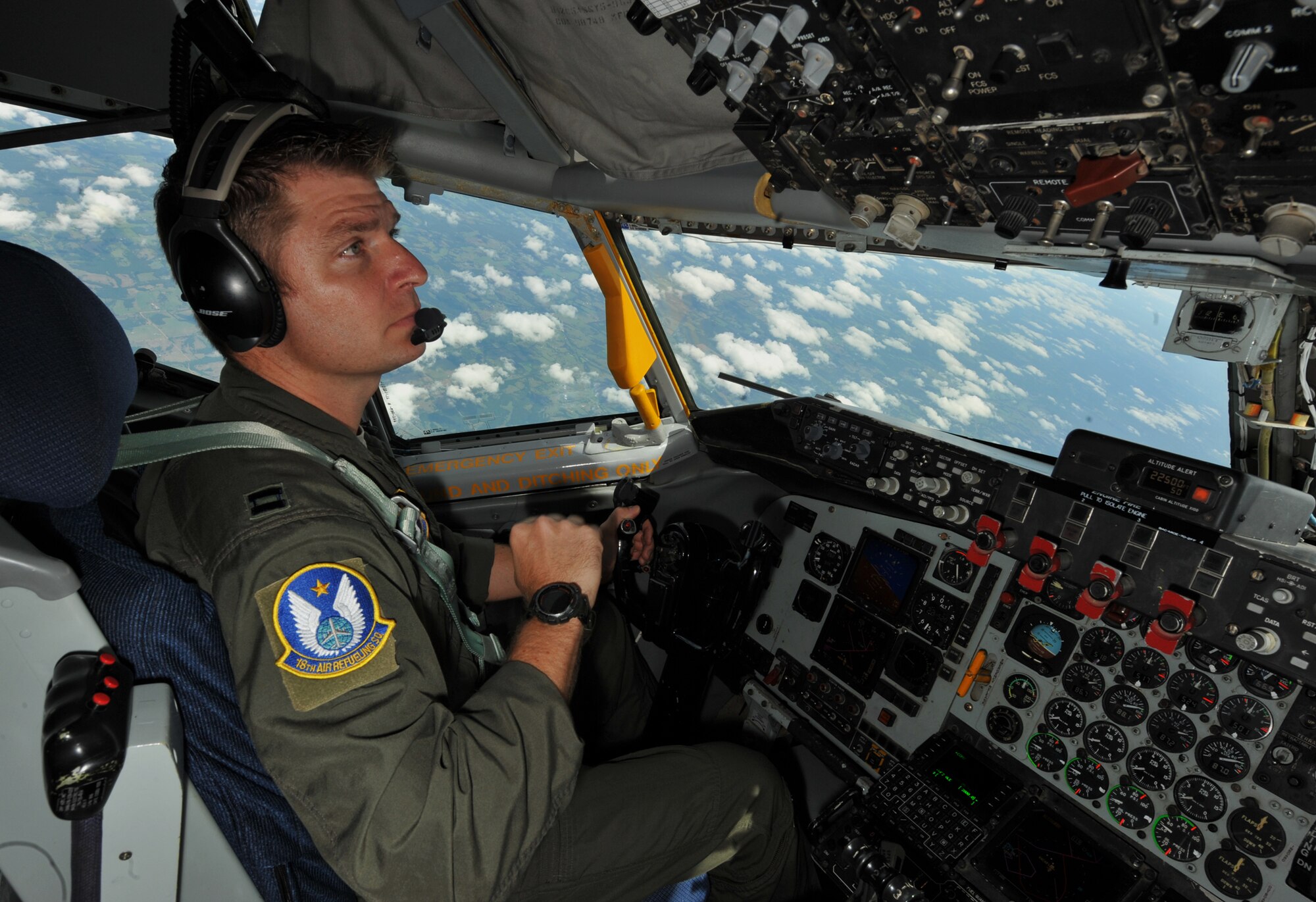Capt. Jason Helmick, a pilot assigned to the Air Force Reserve 18th Air Refueling Squadron, 931st Air Refueling Group, McConnell Air Force Base Kan., checks the cockpit console of a KC-135 Stratotanker while practicing tactical maneuvers over Arkansas, Aug. 3, 2013. Training missions with aerial refueling and tactical maneuvering allow pilots to extend the radius of other aircraft, enabling precision missions around the globe 24 hours a day. (U.S. Air Force photo by Staff Sgt. Jess Lockoski)