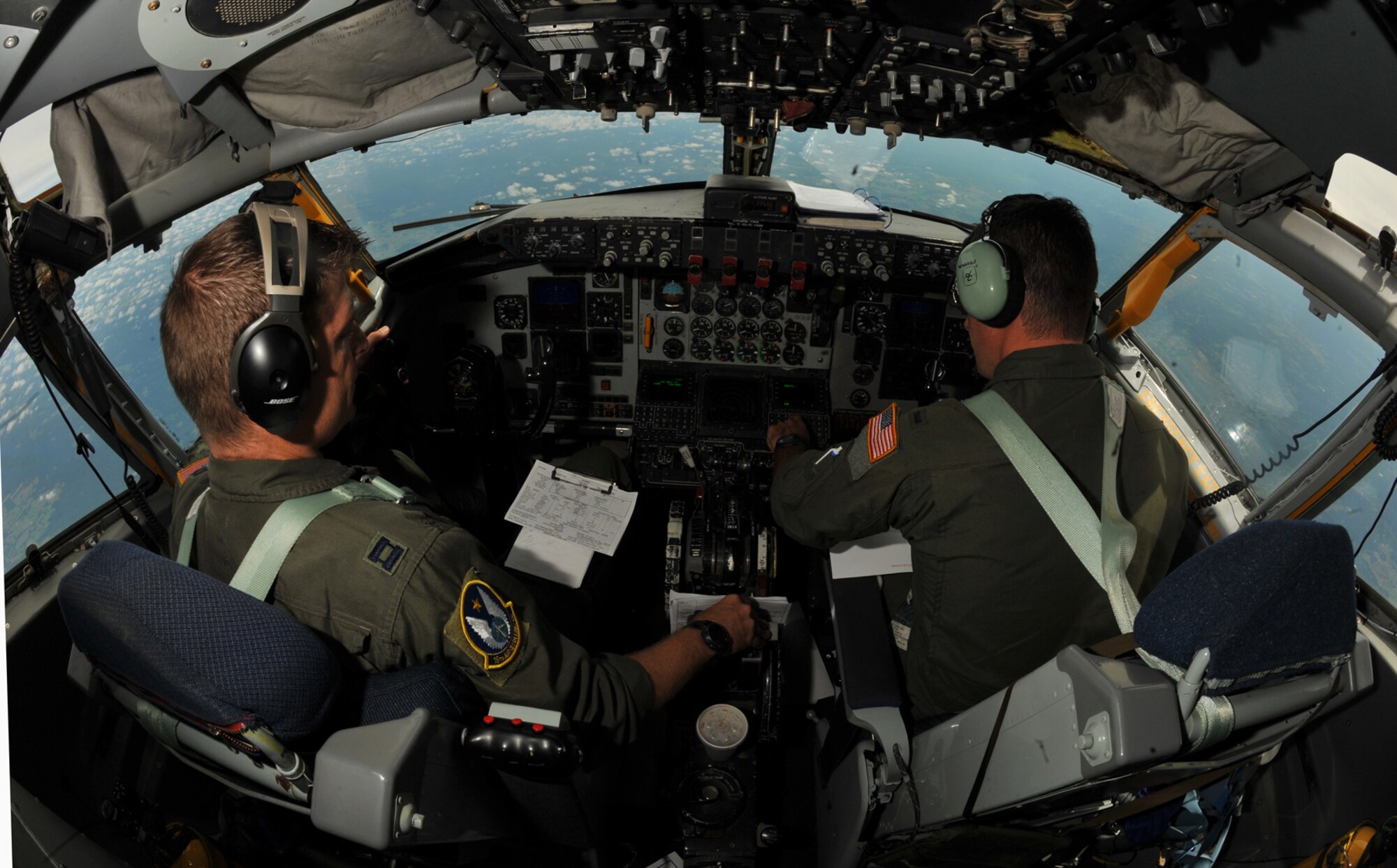 From left to right, Capt. Jason Helmick and 1st Lt. Michael Warren, pilots assigned to the Air Force Reserve 18th Air Refueling Squadron, 931st Air Refueling Group, McConnell Air Force Base Kan., fly a KC-135 Stratotanker during an air refueling training mission, Aug. 3, 2013, over Arkansas. (U.S. Air Force photo by Staff Sgt. Jess Lockoski)