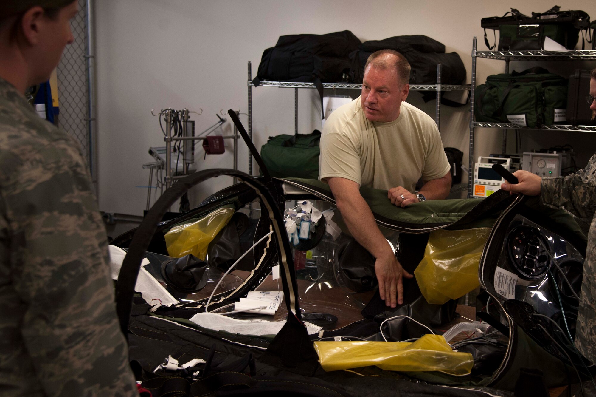 Maj. William Moore, 59th Medical Wing Critical Care Air Transport Team Pilot Unit Coordinator, showcases a Patient Isolation Unit (PIU) during CCATT training at Joint Base San Antonio-Lackland, May, 23, 2013. The (PIU) is a temporary, single-use, portable structure that is designed to fully contain and transport a patient and prevent contamination between the patient, the external environment and the caregivers. The 59th Medical Wing CCAT teams currently have the only PIU mission in the entire Department of Defense. (U.S. Air Force photo/Staff Sgt. Corey Hook)





