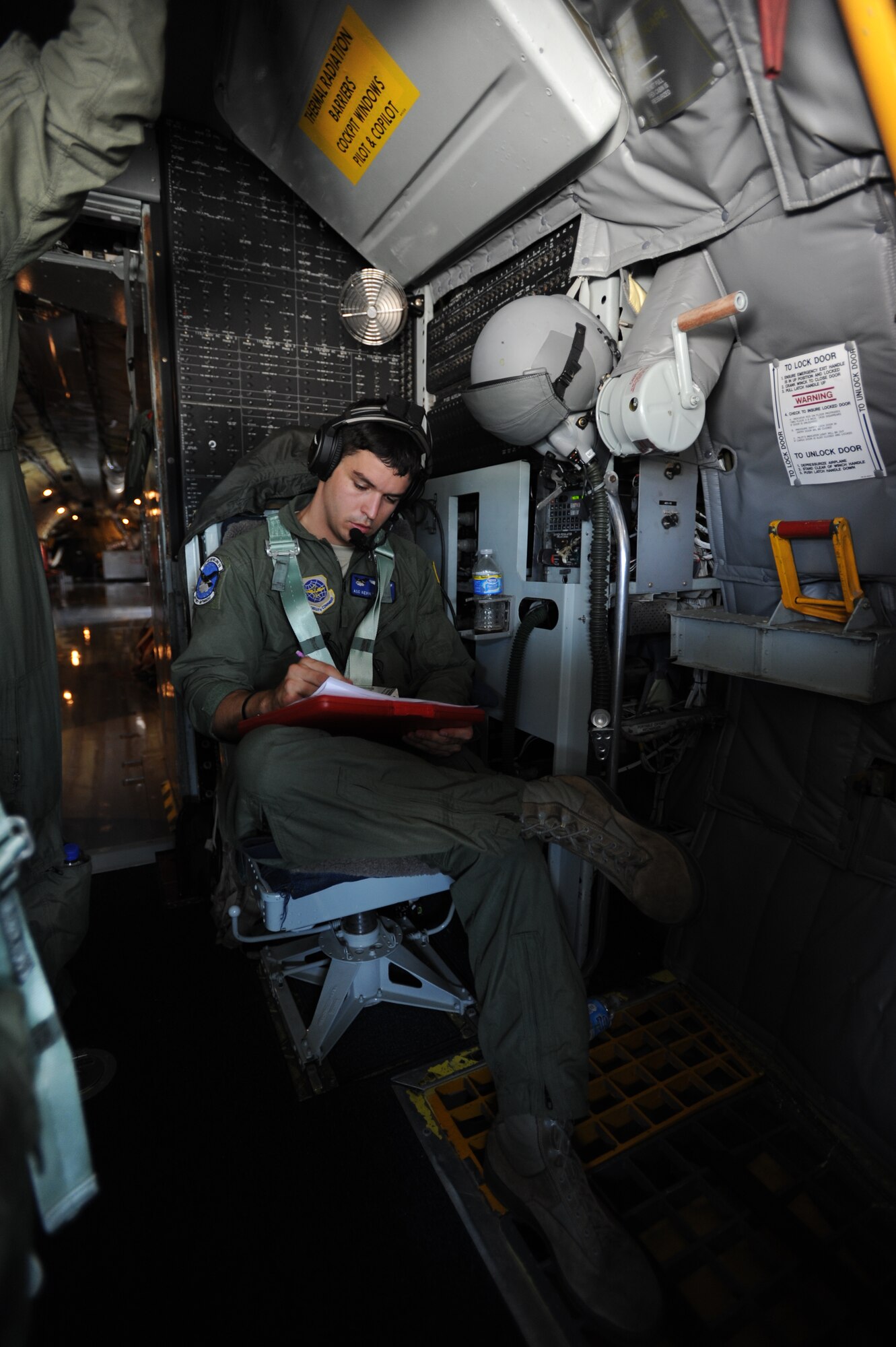 Airman 1st Class Kevin Berneburg, 334th Air Refueling Squadron boom operator, logs flight information during a in-flight refueling mission Aug. 1, 2013. The weight of each passenger and additional cargo are calculated before each flight, helping the boom to find the plane’s center of gravity. (U.S. Air Force Photo/Airman 1st Class John Linzmeier)