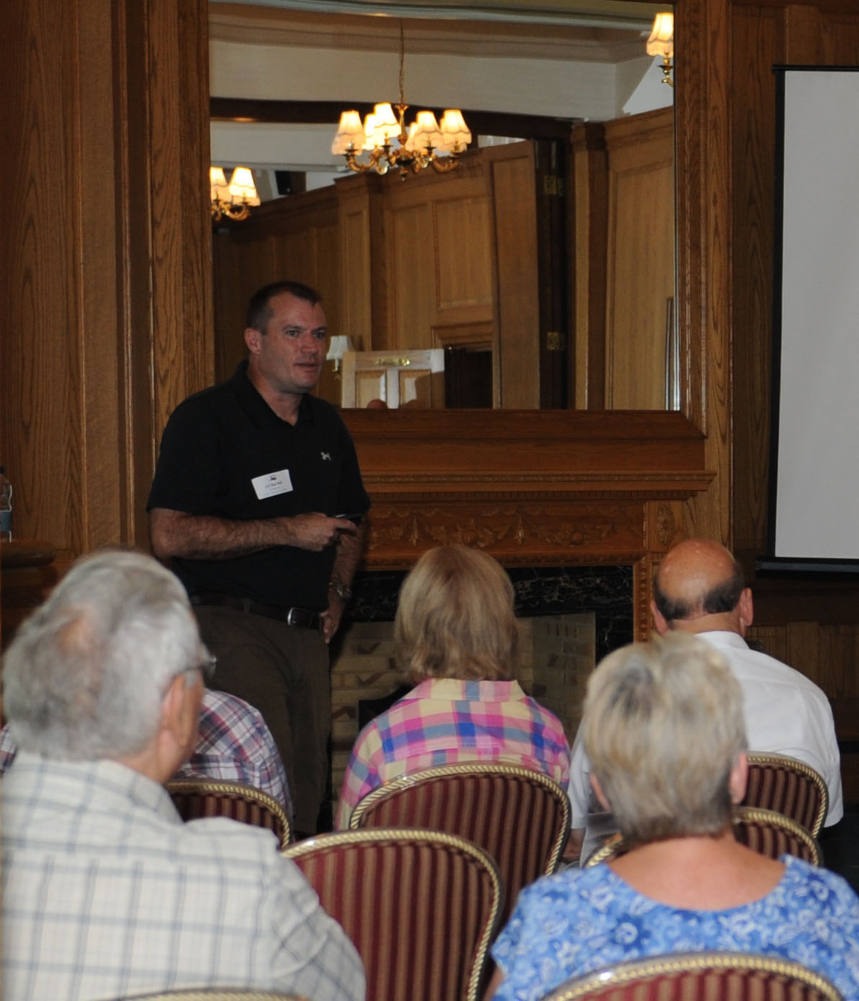 Col. Kenneth T. Bibb Jr., 100th Air Refueling Wing commander, delivers a briefing to local community leaders Aug. 3, 2013, at Middleton Hall on RAF Mildenhall, England. Bibb covered a number of topics, ranging from the economic effect Airmen have on the community to the history of the RAF Mildenhall. The event provided a casual setting where local community leaders could build partnerships with base leadership. (U.S. Air Force photo by Airman 1st Class Preston Webb/Released)