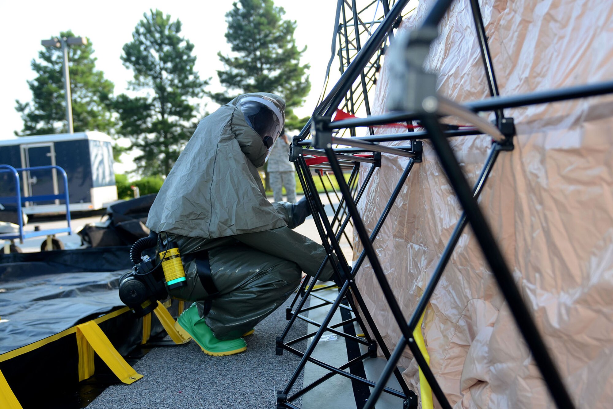 U.S. Air Force Staff Sgt. Jessica Ervin, a medical technician with the 169th Medical Group, team chief for the base Patient Decontamination Team at McEntire Joint National Guard Base, South Carolina Air National Guard, helps set up the stand-alone decontamination shelter, July 18, 2013. The team is trained to provide decontamination capabilities for a maximum of 100 patients during the 0-6 hour timeframe after an event occurring that would require their assets.   (U.S. Air National Guard photo by Tech. Sgt. Caycee Watson/Released)