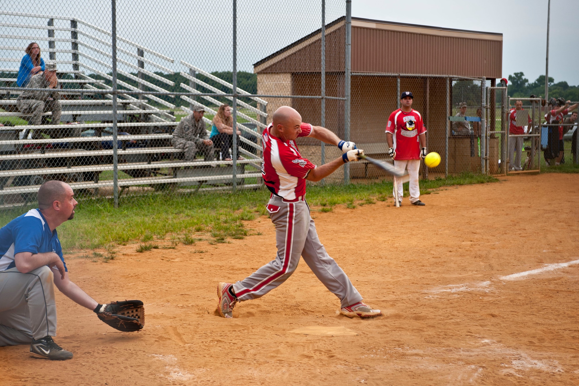 U.S. Air Force Staff Sgt. Brandon Bridges, 633rd Civil Engineer Squadron structures craftsman, swings at a ball during the intramural softball championship at Langley Air Force Base, Va., July 31, 2013. The 633rd CES scored a 13-6 victory over the Air Combat Command Installations and Missions Support Directorate team. (U.S. Air Force photo by Staff Sgt. Stephanie Rubi/ Released)