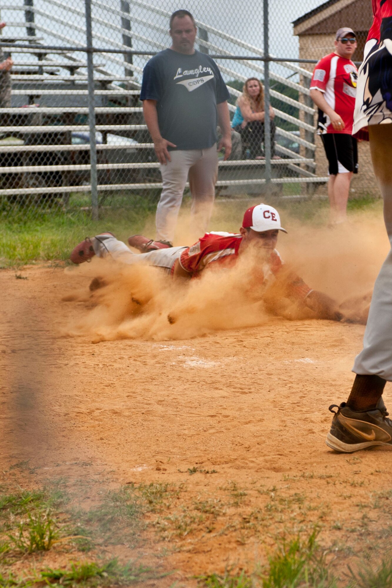 U.S. Air Force 2nd Lt. Wade Burkett, 633rd Civil Engineer Squadron project programmer, slides into home base during the intramural softball championship at  Langley Air Force Base, Va., July 31, 2013. Burkett said the season's games boosted morale and camaraderie for Service members.  (U.S. Air Force photo by Staff Sgt. Stephanie Rubi/ Released)