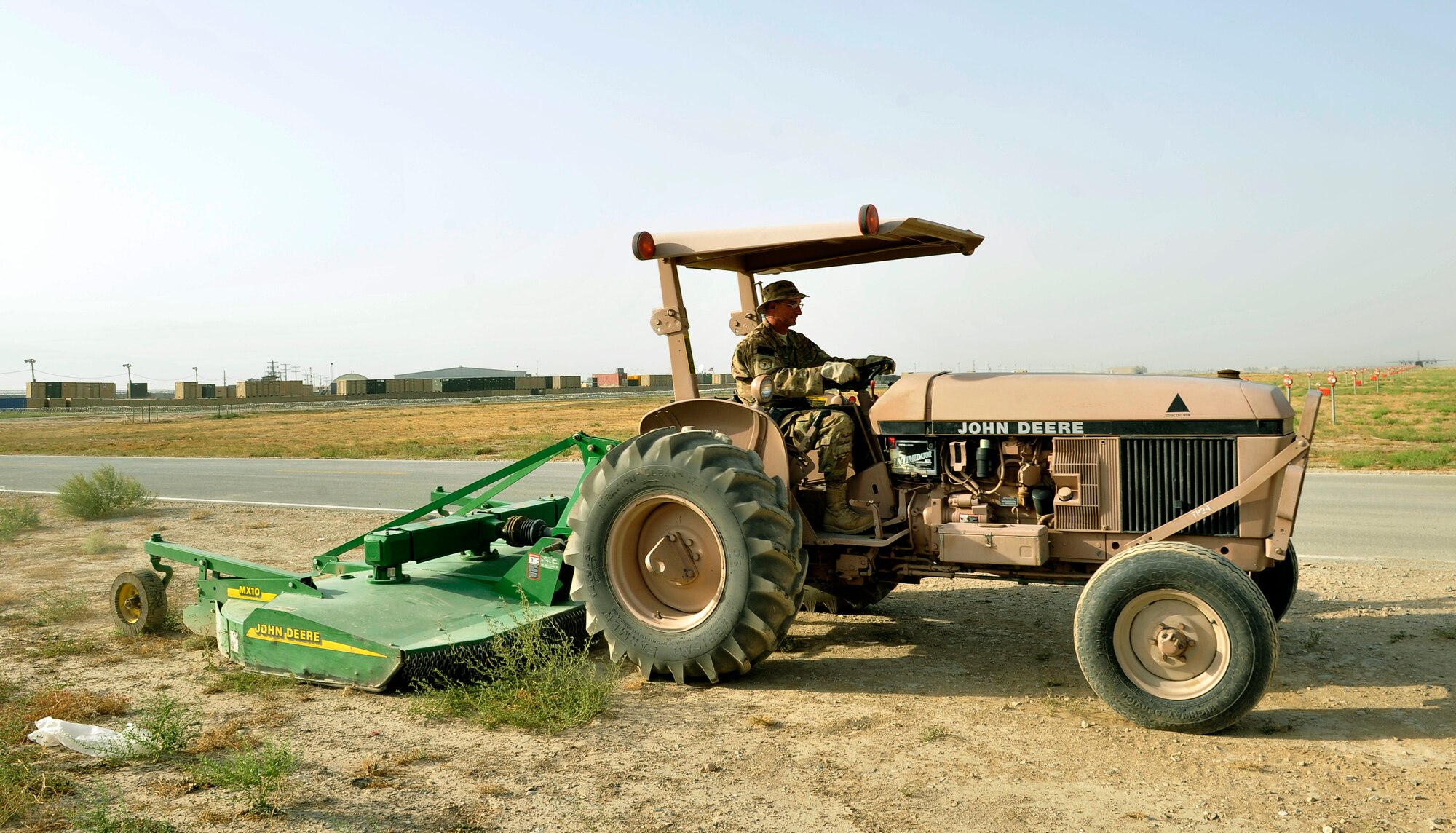 Staff Sgt. Richard Skinner, 455th Expeditionary Civil Engineering Squadron, heavy equipment journeyman,mows the grass around the Bagram Airfield, Afghanistan, July 31, 2013. The CE squadron here recently took over the mission and has reduce bird strikes signifigantly. He is deployed from Little Rock Air National Guard, Ark. (U.S. Air Force photo/ Staff Sgt. Stephenie Wade)
